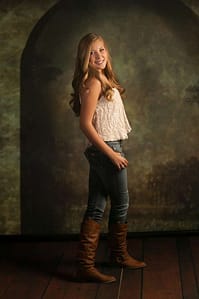 Senior girl in studio jeans and boots